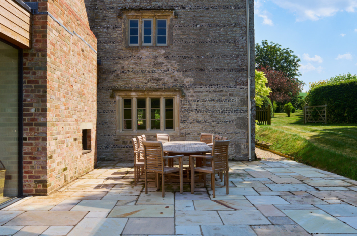 Wiltshire Farm House  dining terrace with restored stone mullioned window